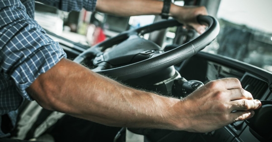 close up of a large truck driver shifting gears