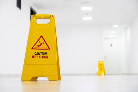 Wet Floor sign in bright hallway
