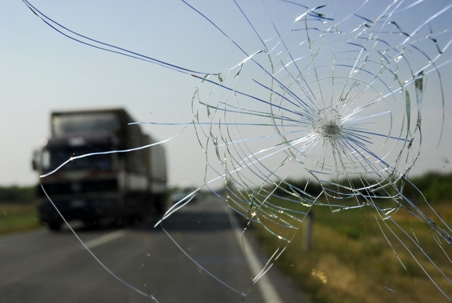 broken windshield with truck in background